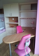 Finální realizace interiéru dětského pokoje, záběr na židle, stůl a skříň